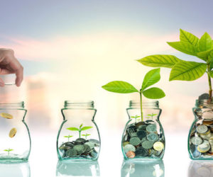 45039067 - hand putting mix coins and seed in clear bottle on cityscape photo blurred cityscape ,business investment growth concept